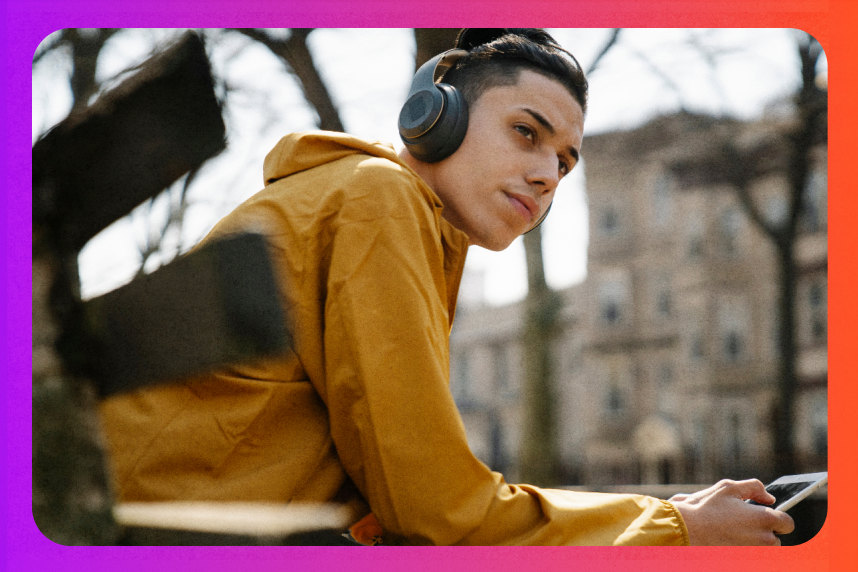 Young person sitting on a bench listening to music