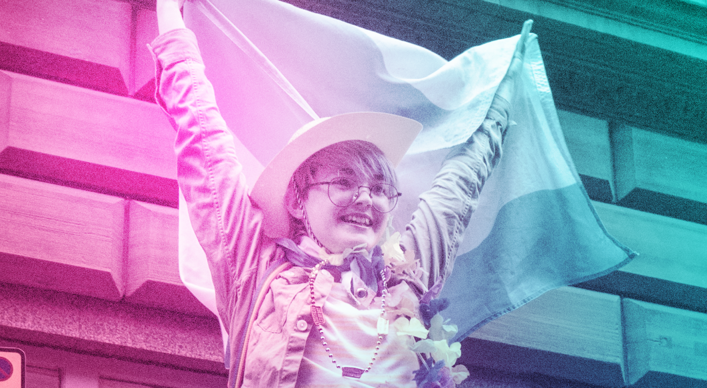 Young person proudly holding the trans flag