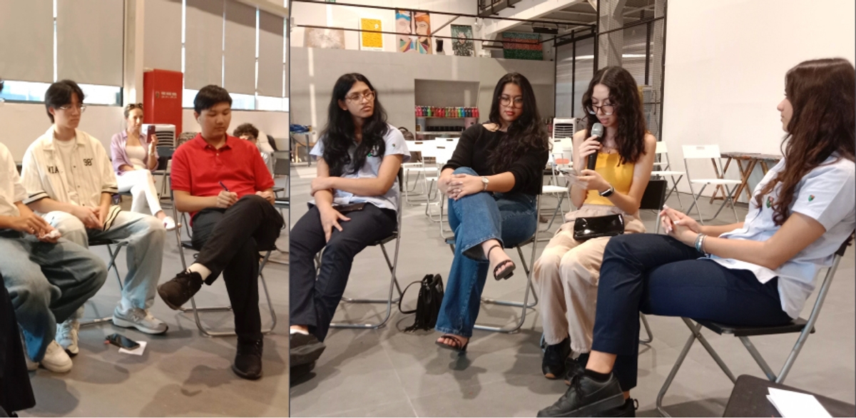 A diverse group of individuals engaged in a discussion during a community service workshop, sitting in a circle on folding chairs. The environment is bright and welcoming, emphasizing collaboration and civic engagement.
