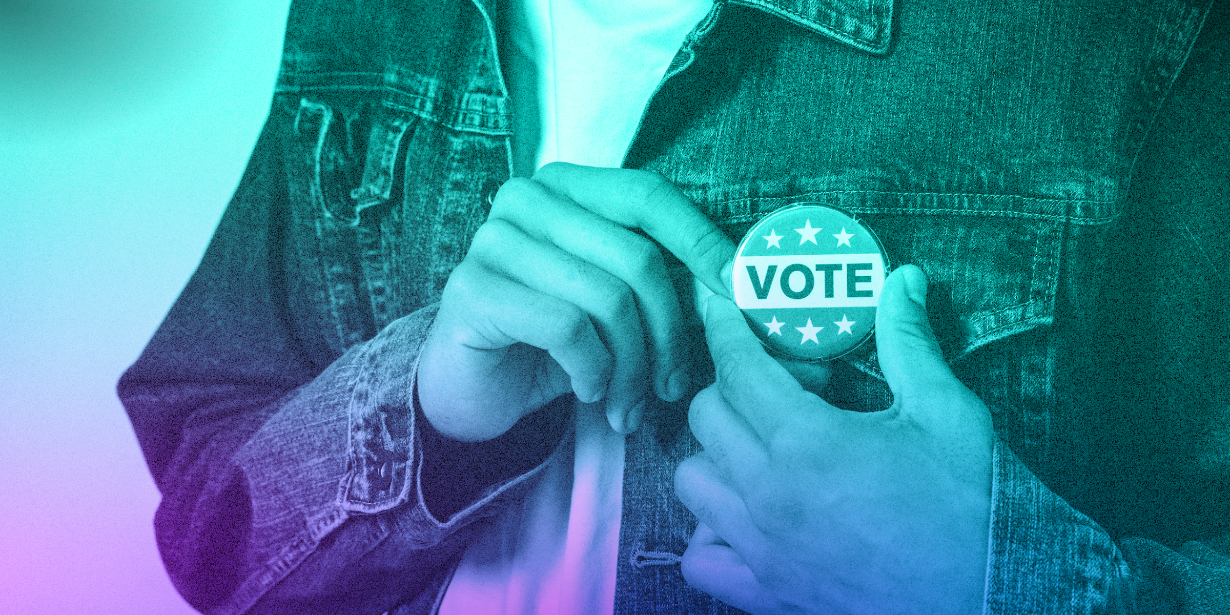 Zoomed into a person pinning a button that says "VOTE" on it to their jacket