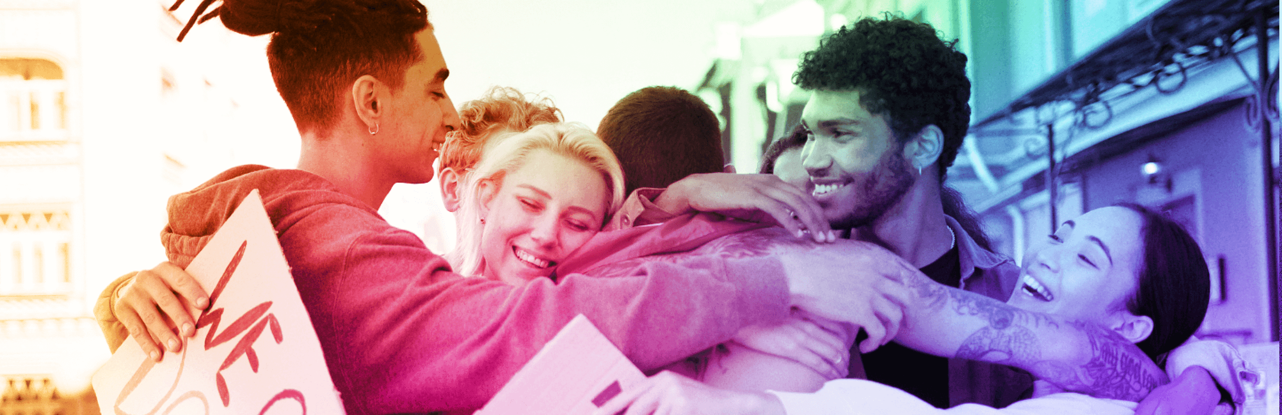 A gradient colored photo of young people embracing one another, holding a sign that reads, "We Can Do It"