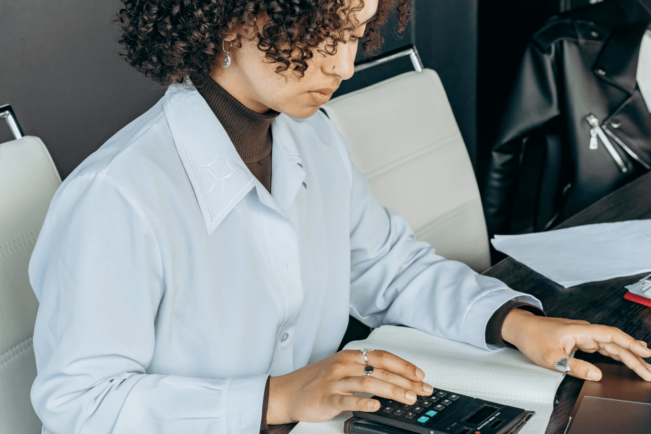 A young professional is determining a mathematical result using their calculator.