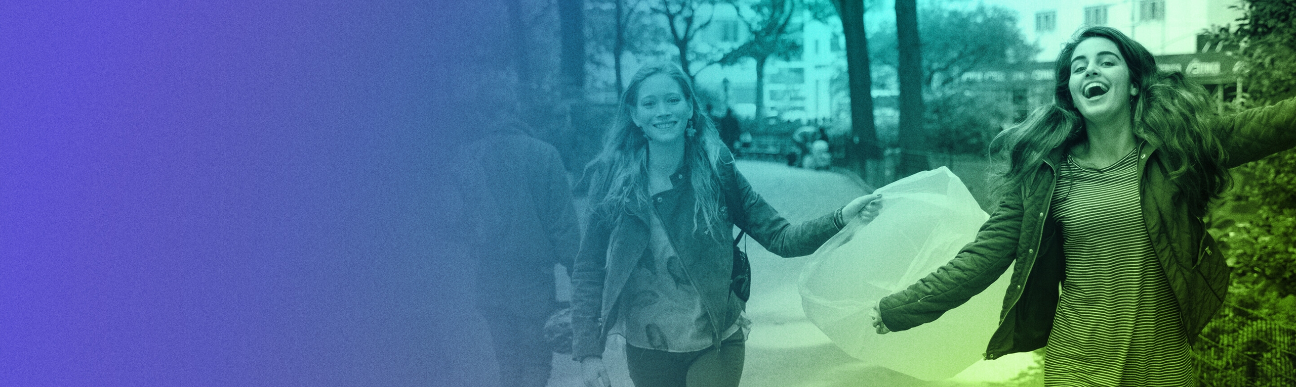 Two joyous, smiling young people running to collect trash with a plastic trash bag