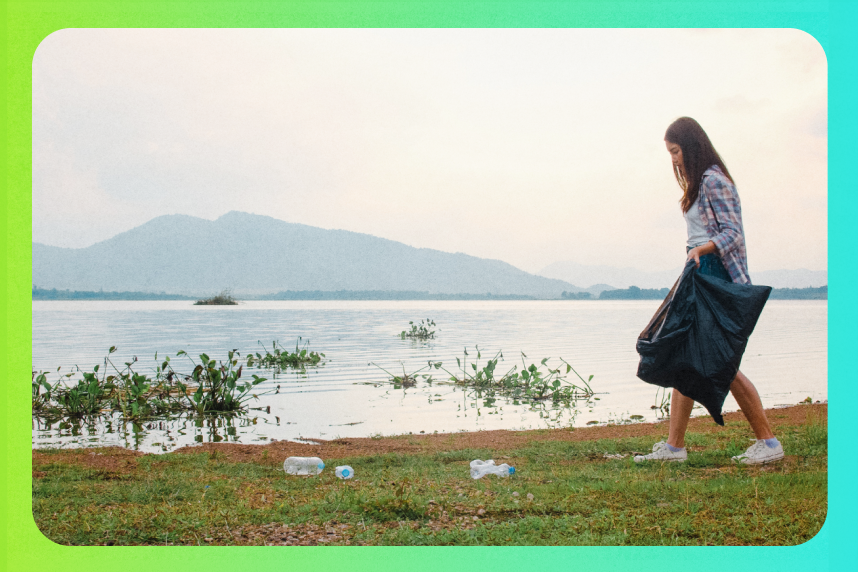 Person picking up trash on a beach