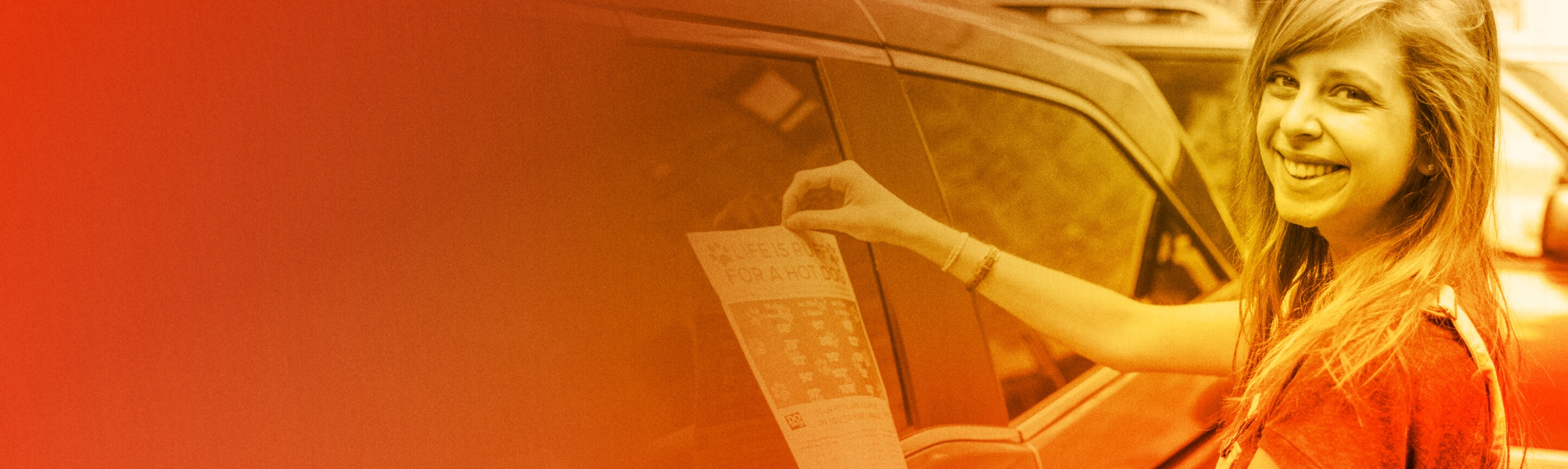 A member tapes an informational sheet to a car window.