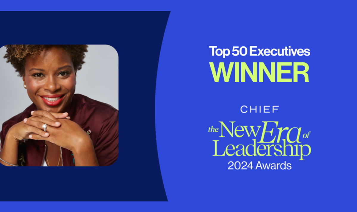 A smiling individual with curly hair poses confidently, showcasing their accomplishments. The image highlights their recognition as a 'Top 50 Executives Winner' for the 2024 New Era of Leadership Awards.