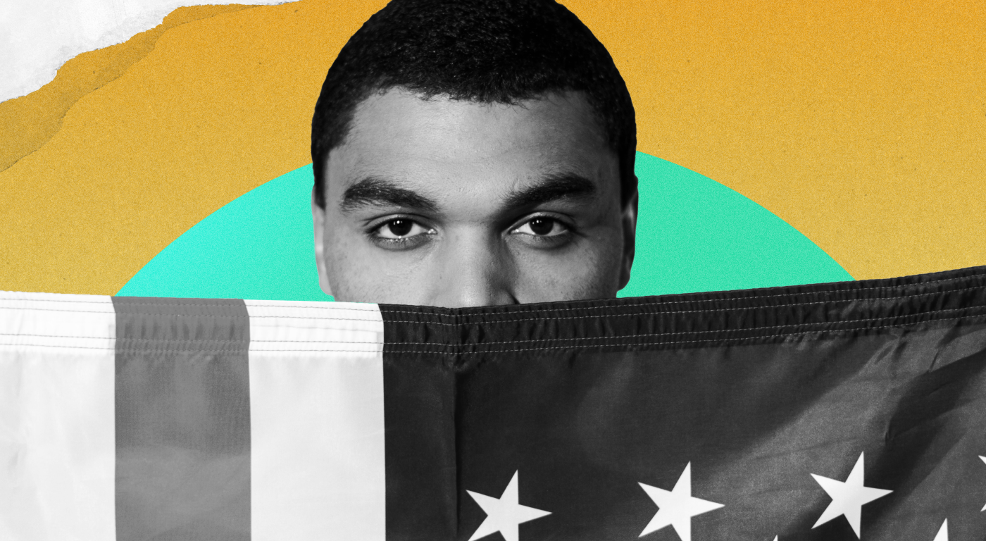 Young Black person whose face is partially obscured by an American flag