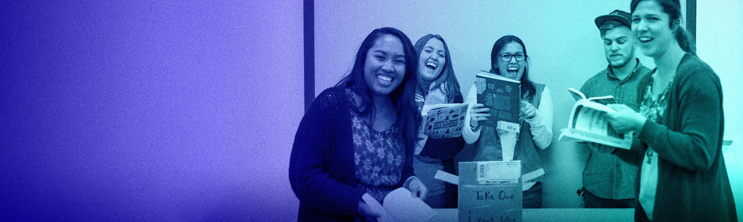 A group of DoSomething members holding books and laughing