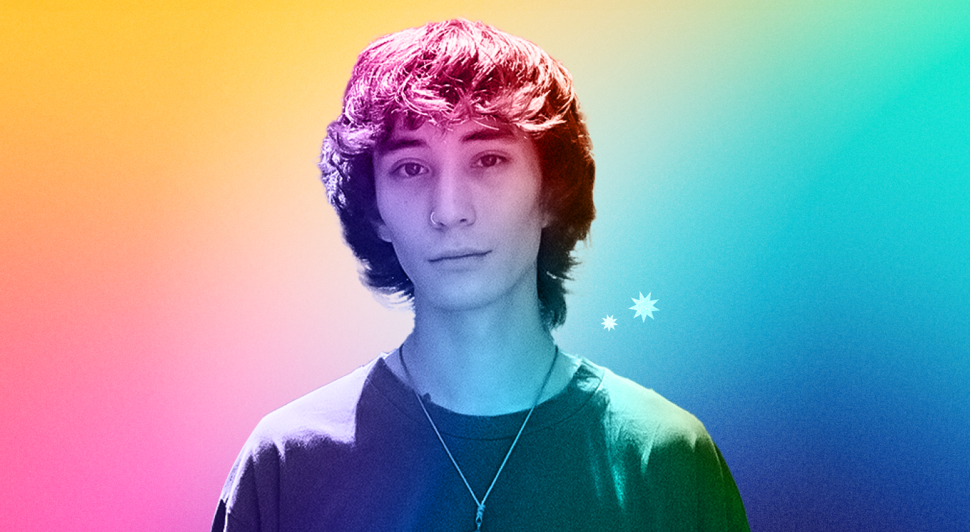 Maksim Batuyev with shaggy hair and a nose ring looking straight out, on a multi color abstract gradient background