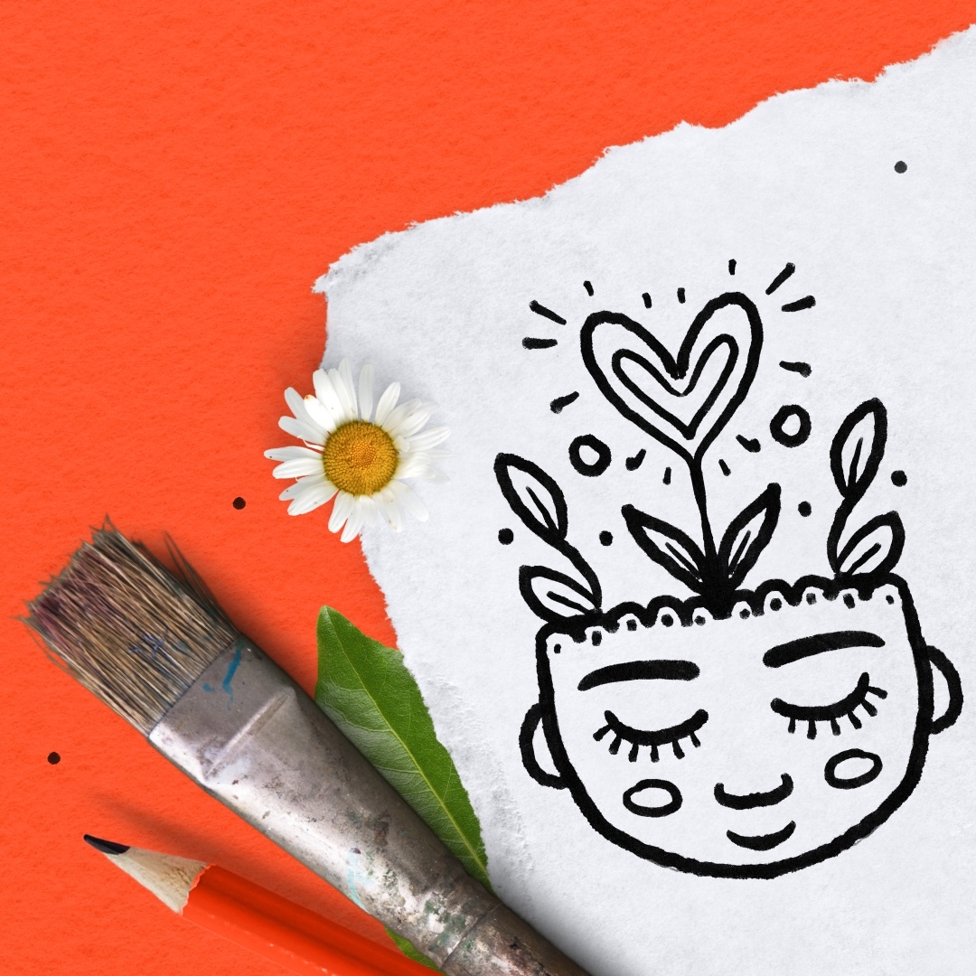 doodle of a head with a heart shape flower growing from the top. Laying out with a paintbrush, pencil, and a daisy.