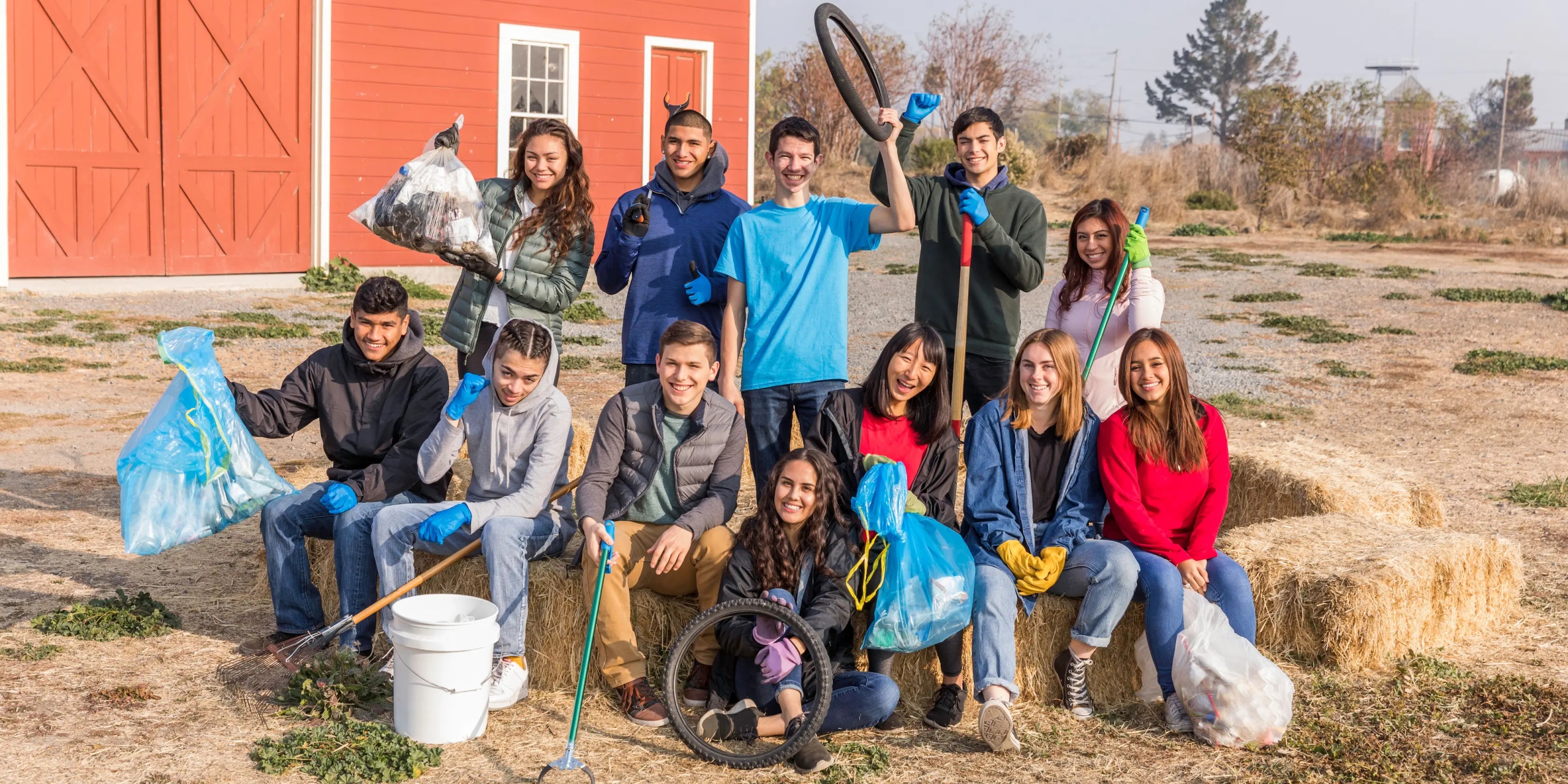 Group of young adults cleaning up a farm.