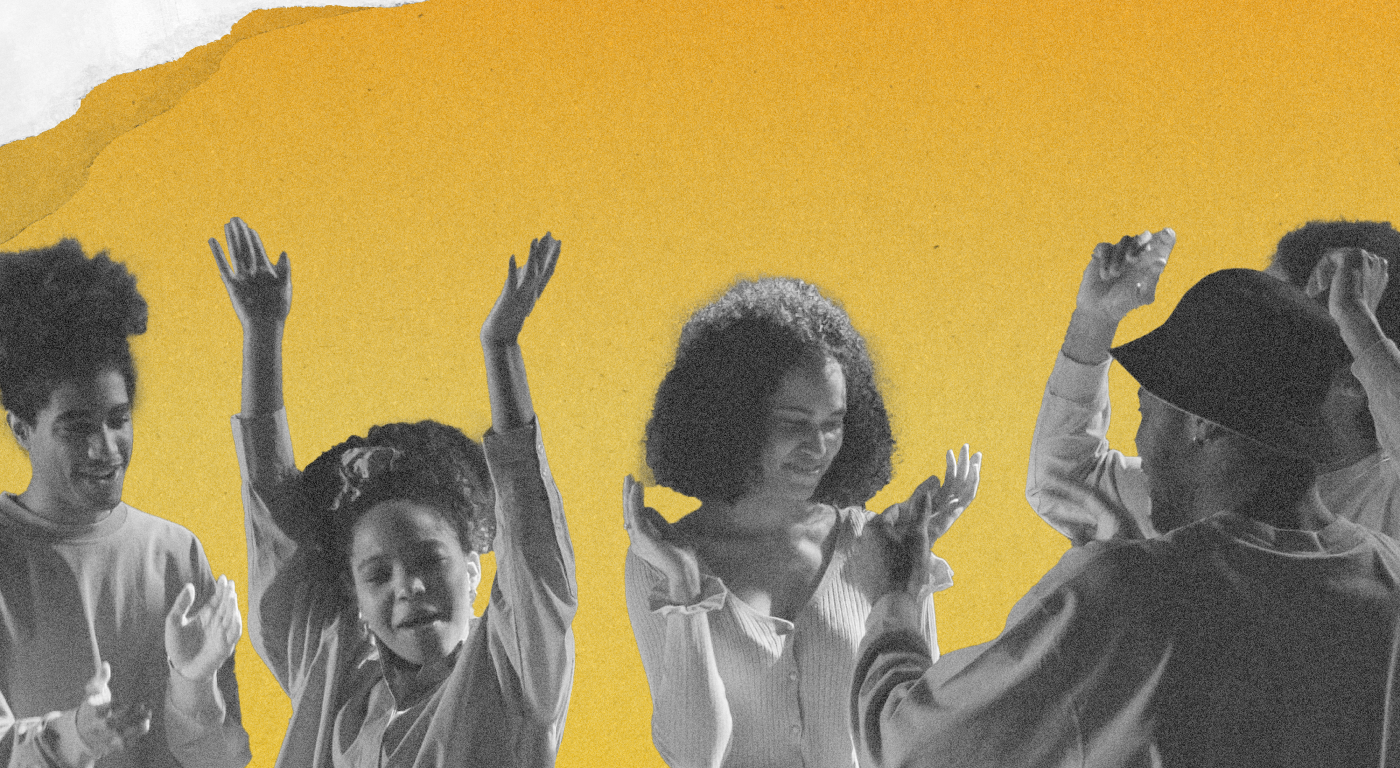 Group of five young Black people dancing happily, arms up and clapping, four have natural hair and one is wearing a hat