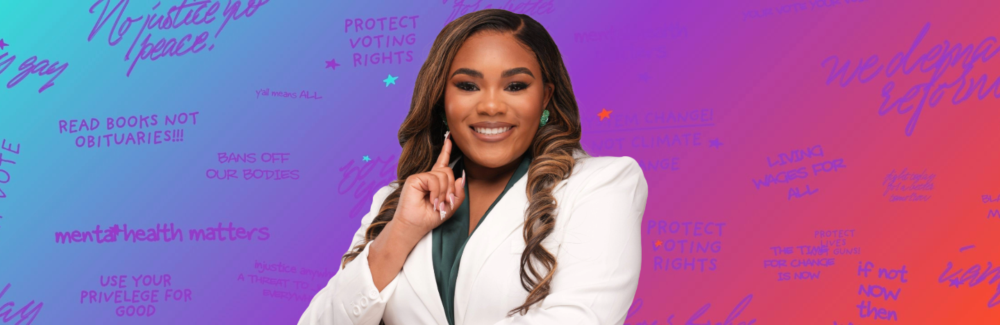 A smiling individual in a white blazer gestures confidently against a vibrant background filled with empowering phrases about social justice, voting rights, and community engagement. This image represents opportunities for volunteering and civic leadership, promoting active participation in societal change.