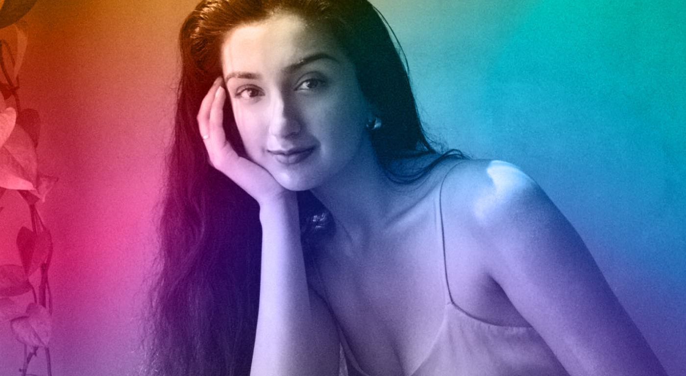 Warm to cool gradient portrait of Aditi Mayer with long loose hair and tank top