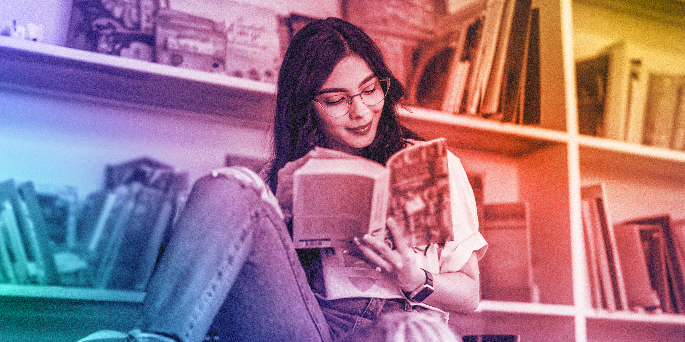 A blue, green, red, orange and yellow gradient graphic of a young adult in front of a library shelf of books, joyously reading a book.