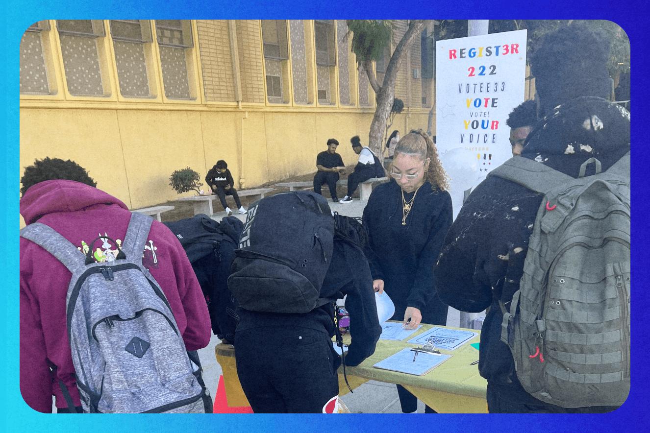 Young people on their school campus registering to vote