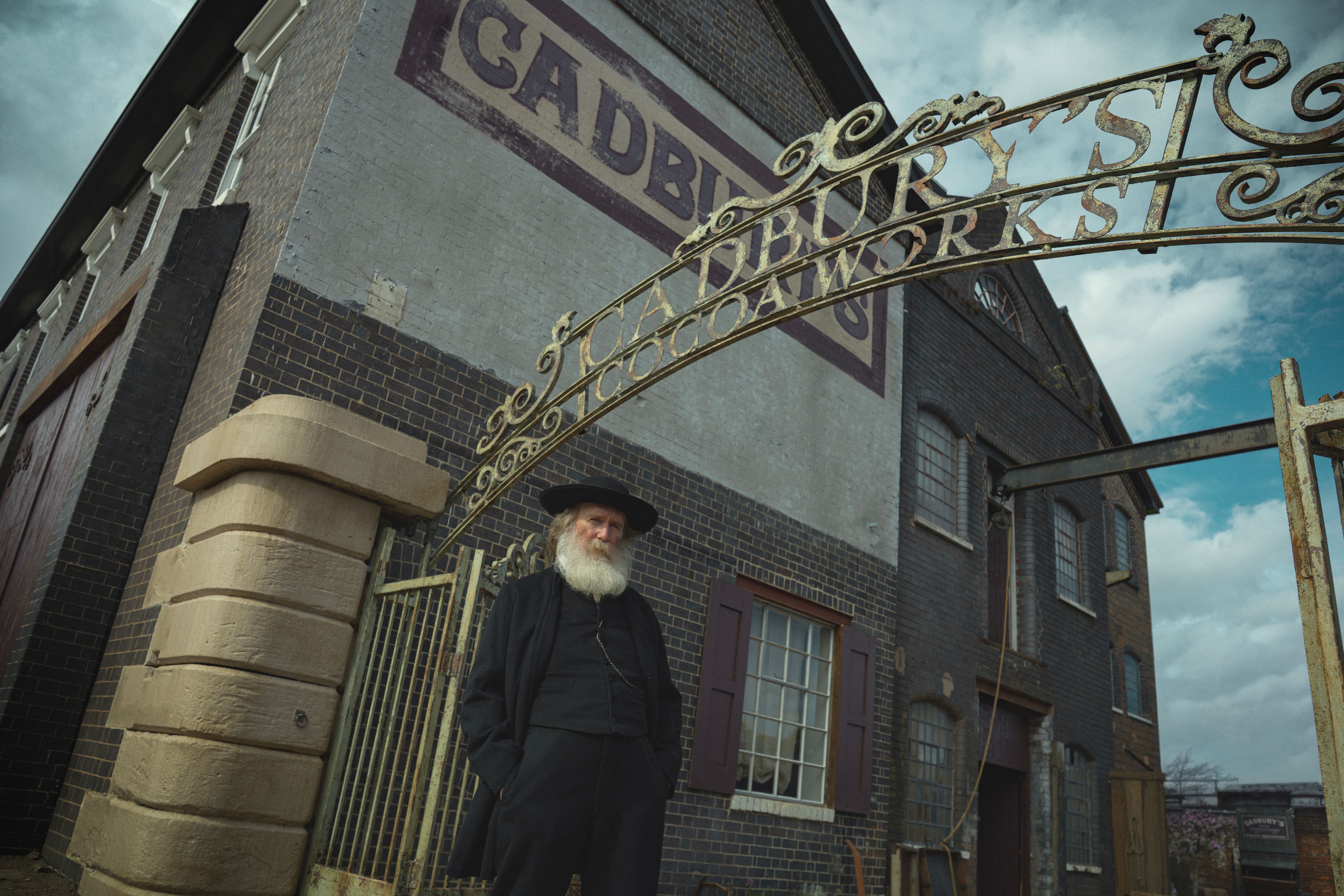 Pearce Quigley as John Cadbury outside the Cadbury factory