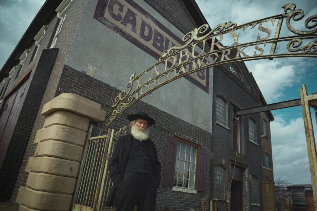 Pearce Quigley as John Cadbury outside the Cadbury factory