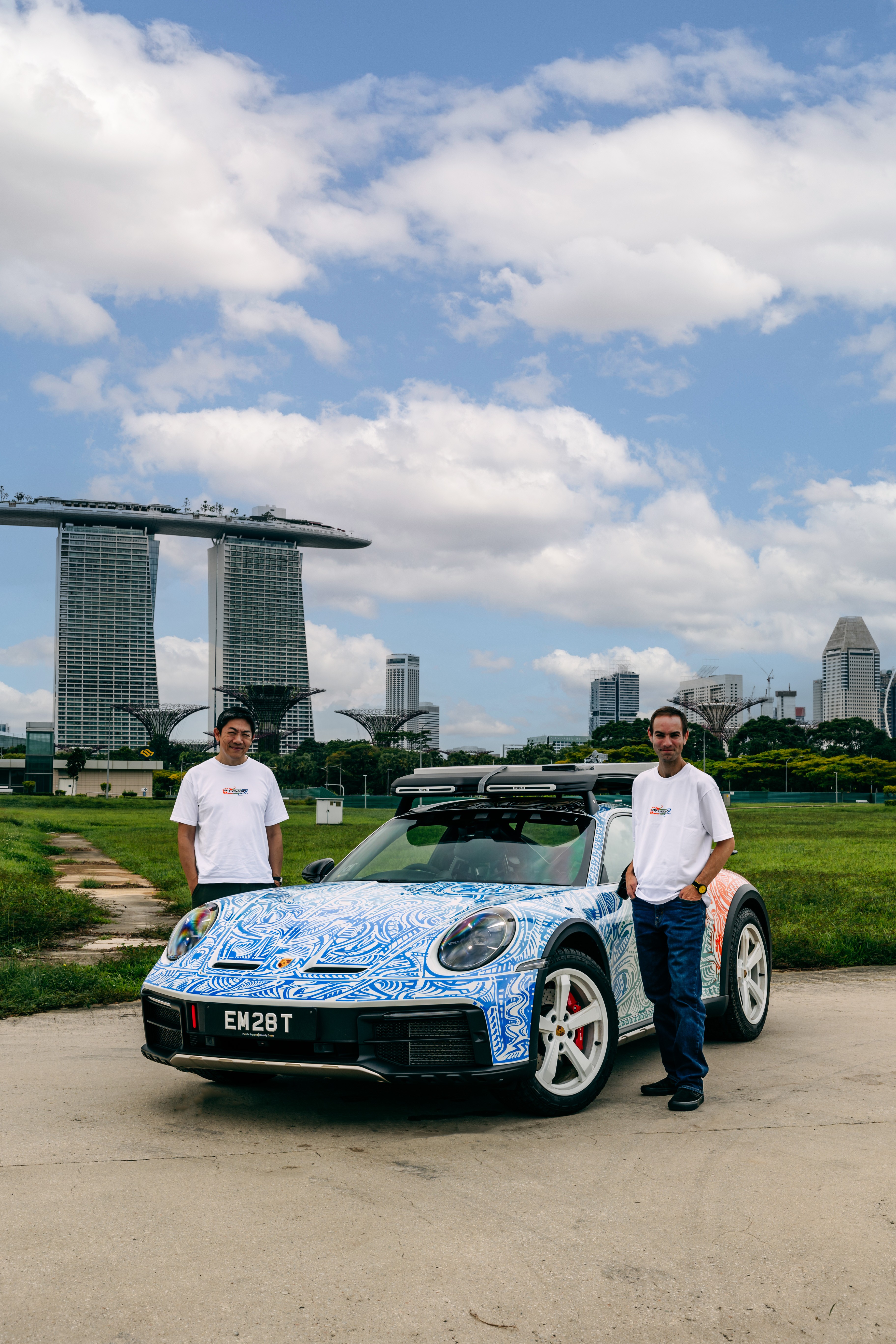 Colin Auto Icons and Chris Dunlop standing next to Porsche 911 DakarT in Singapore