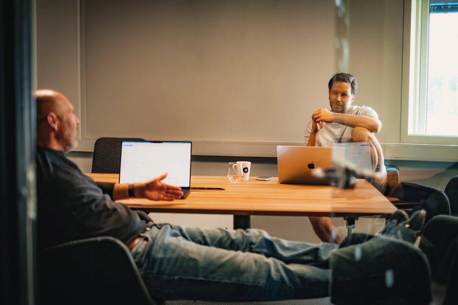 Colleagues having a conversation in a meeting room