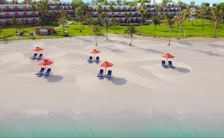 Sunloungers and parasols on the beach at JA Palm Tree Court