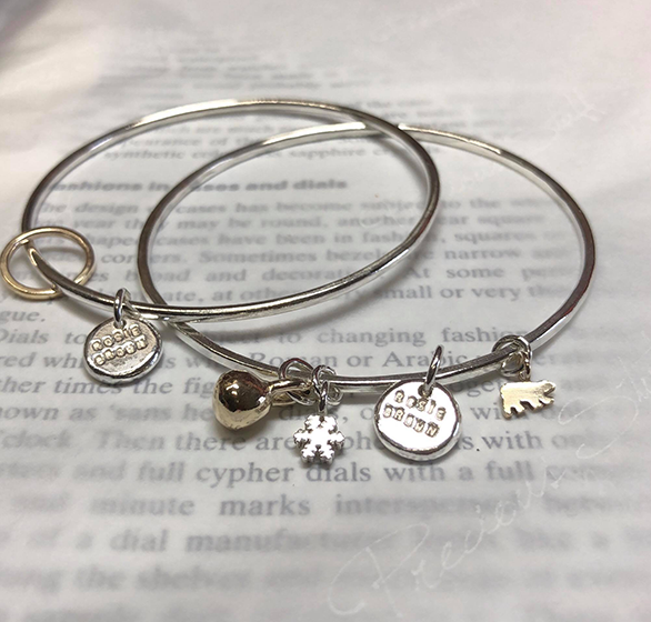 Silver charm bangles by Rosie Brown