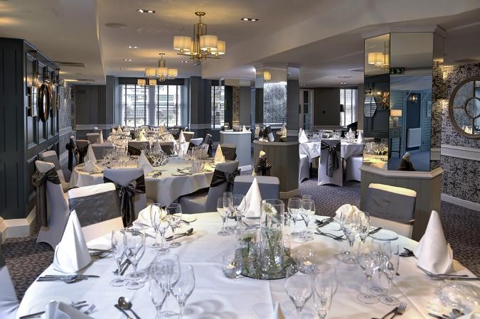 Function room set for a banquet with white tablecloths