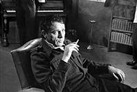 Black-and-white photo of a man smoking in an armchair