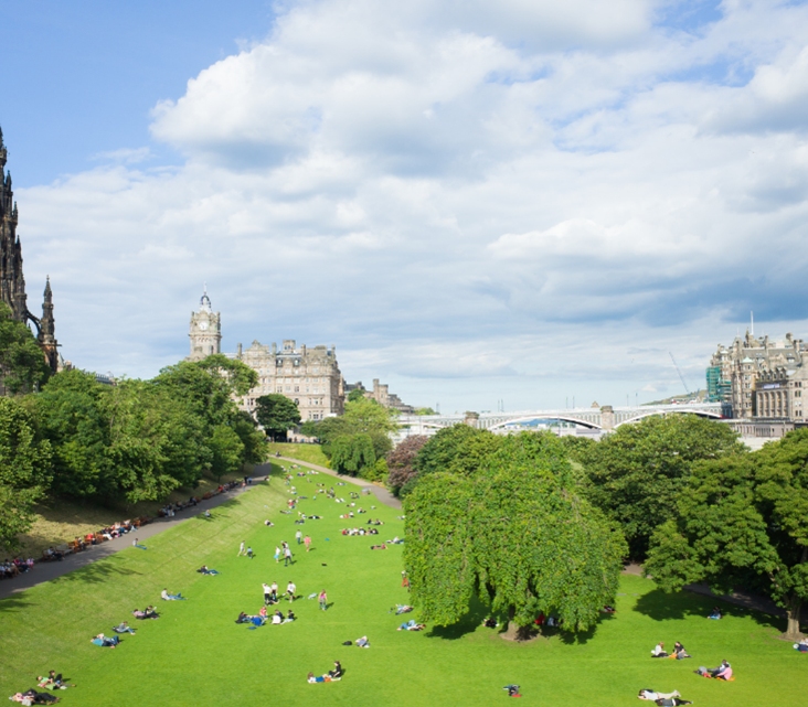 People relaxing on the grass in Princes Street Gardens