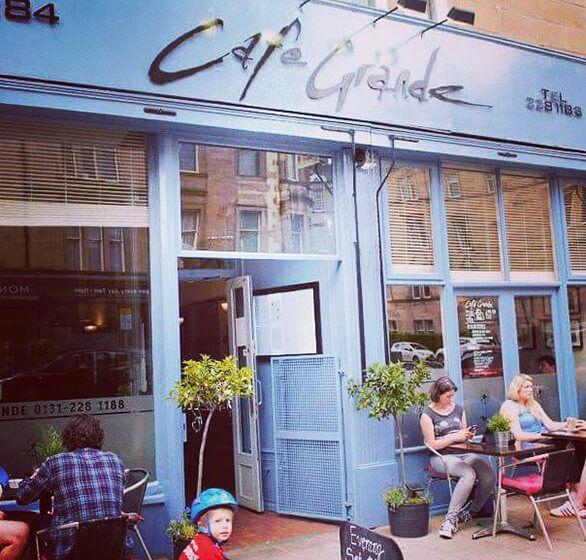 Café Grande's blue shopfront with tables outside