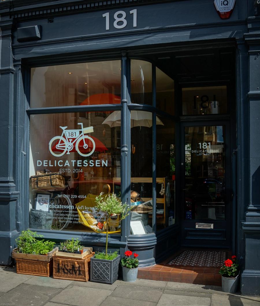 Shopfront of a delicatessen with a bicycle sign