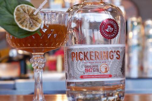 Bottle of Pickering's gin beside a cocktail