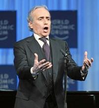 Man in a suit singing on stage