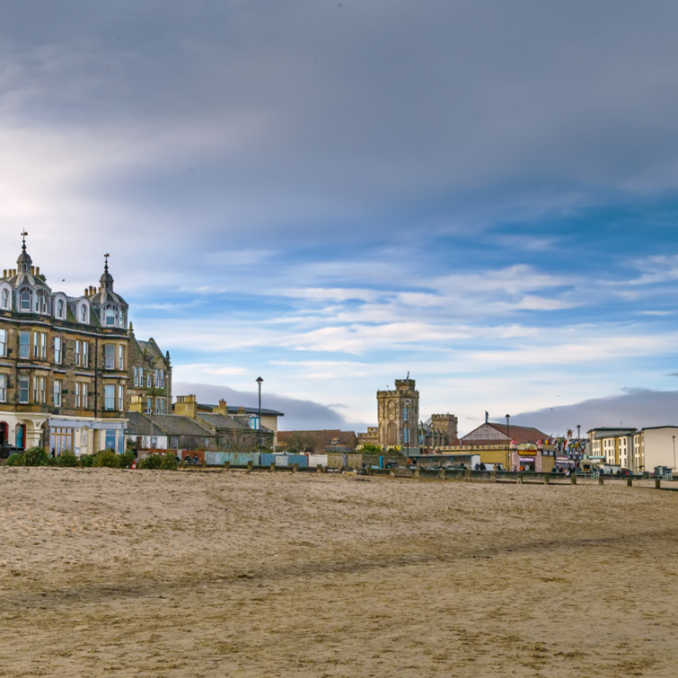Portobello beach and promenade under a cloudy sky