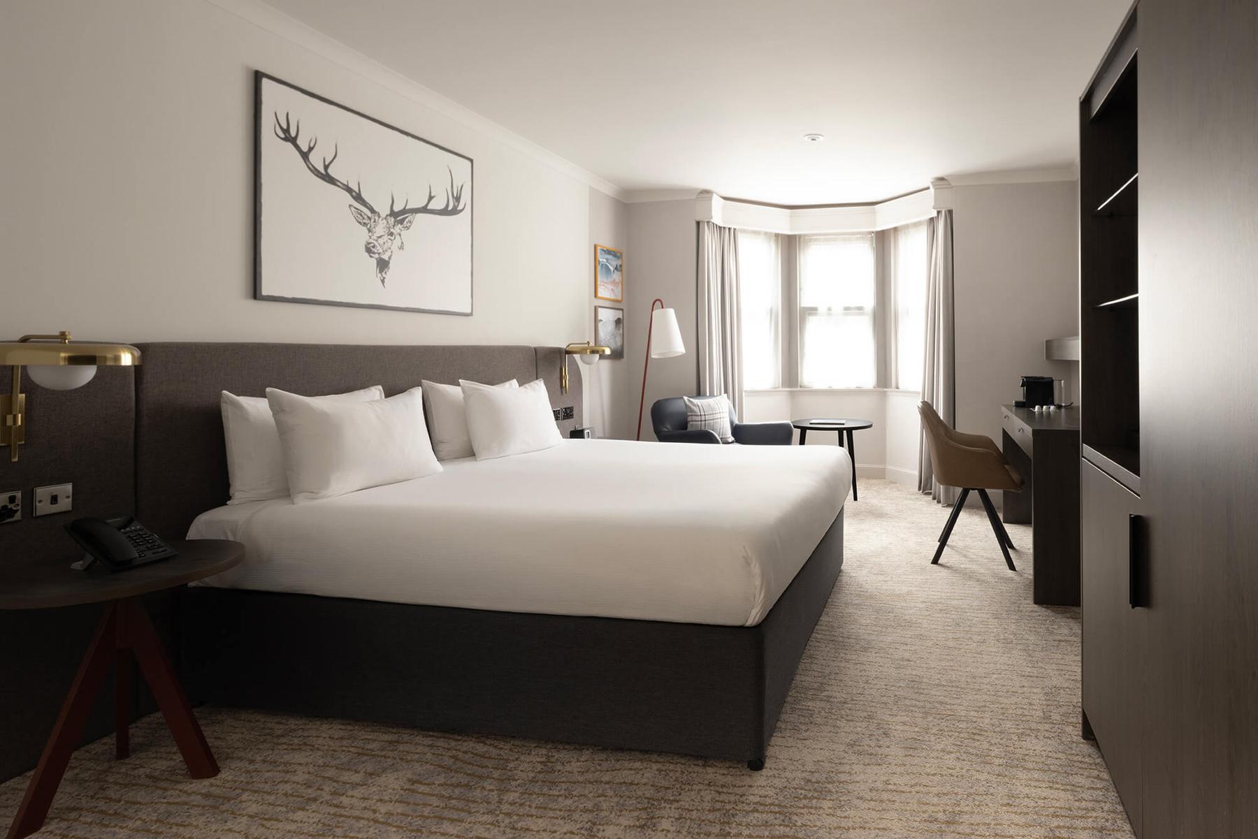 Executive double bedroom with a stag print above the bed