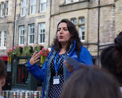 Invisible Cities guide talking to a tour group on an Edinburgh street