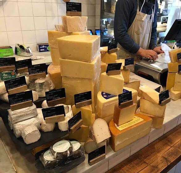 Cheeses piled high on the counter at Mellis Cheese
