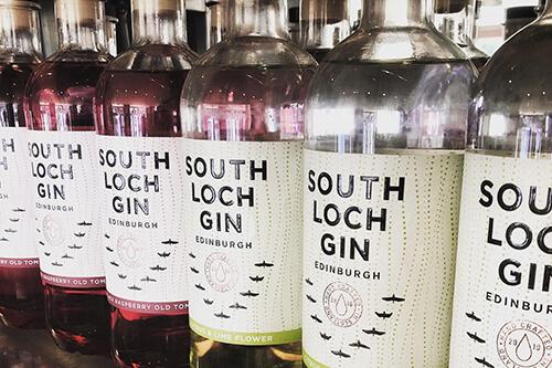 Rows of South Loch gin bottles