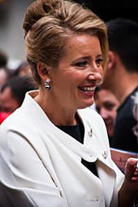 Smiling woman in a white jacket at an event