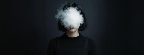 Smoke in front of face of lady
