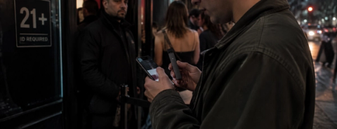Illustration of a person holding a phone and vaping device beside a venue sign requiring identification for entry.