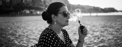 Lady vaping on beach