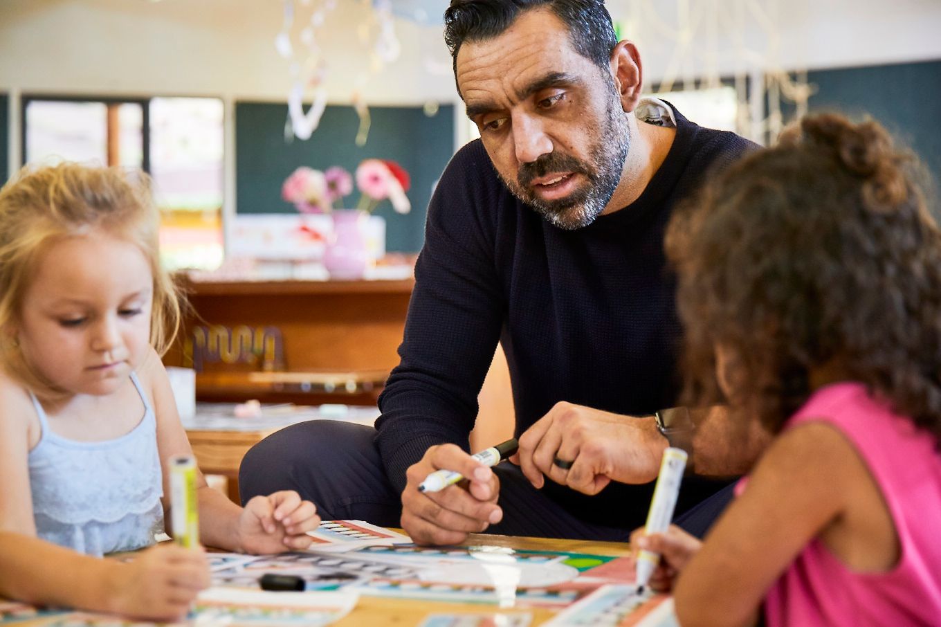ALNF ambassador Adam Goodes reading to a child
