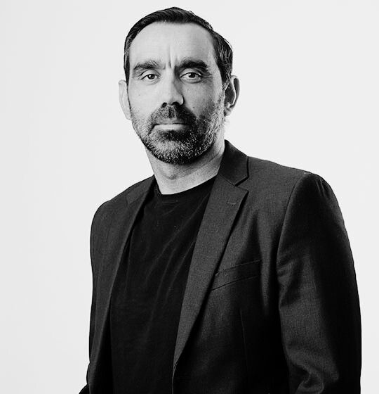 Black and white portrait photo of Adam Goodes