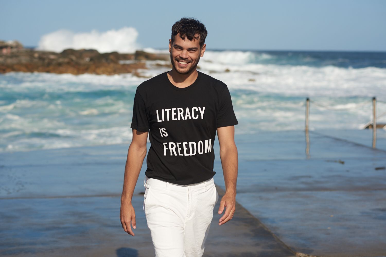 Nathan McGuire smiling on a beach