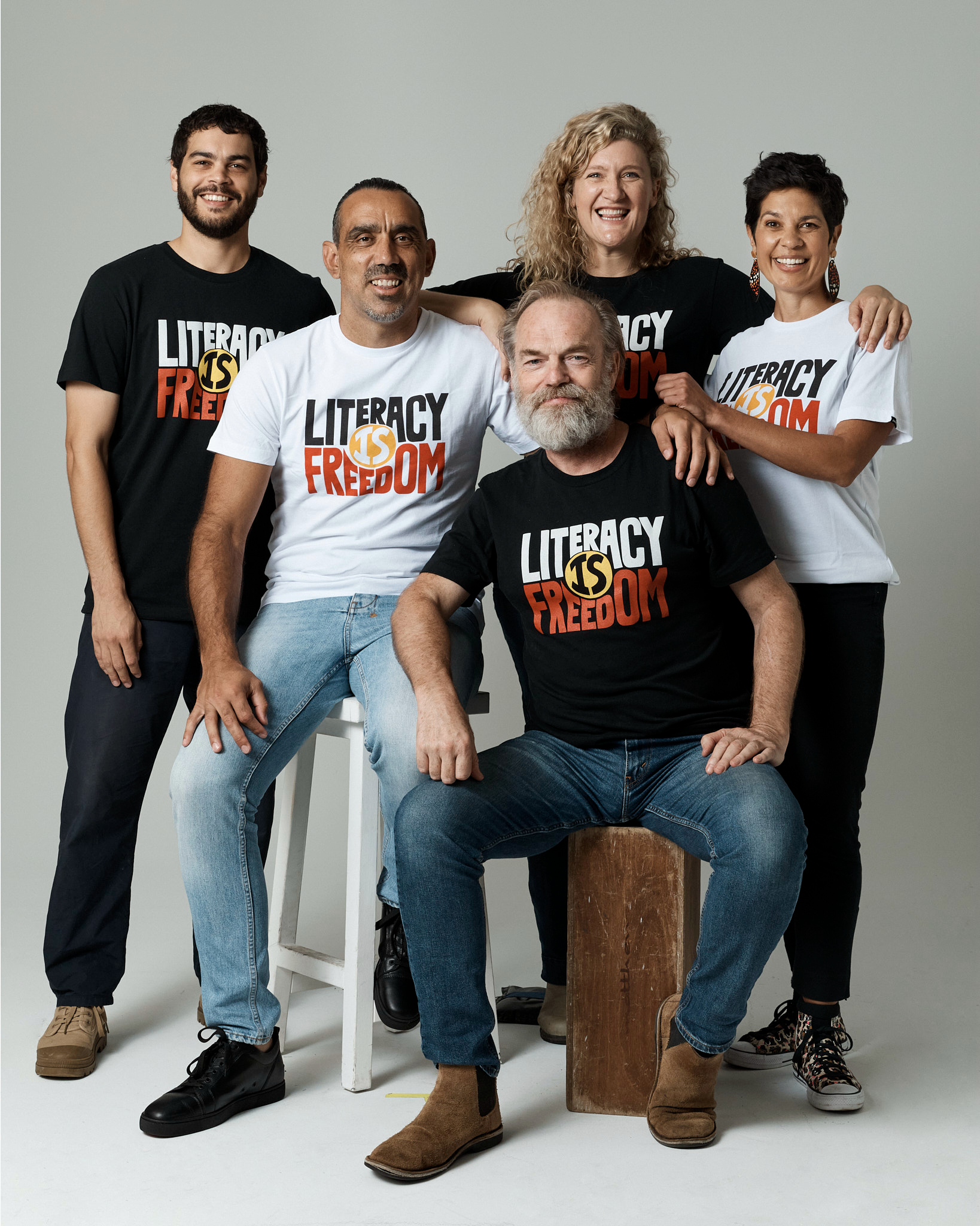 ALNF ambassadors grouped together wearing the ALNF t-shirt on a photo backdrop