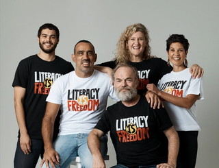 ALNF ambassadors grouped together wearing the ALNF t-shirt on a photo backdrop
