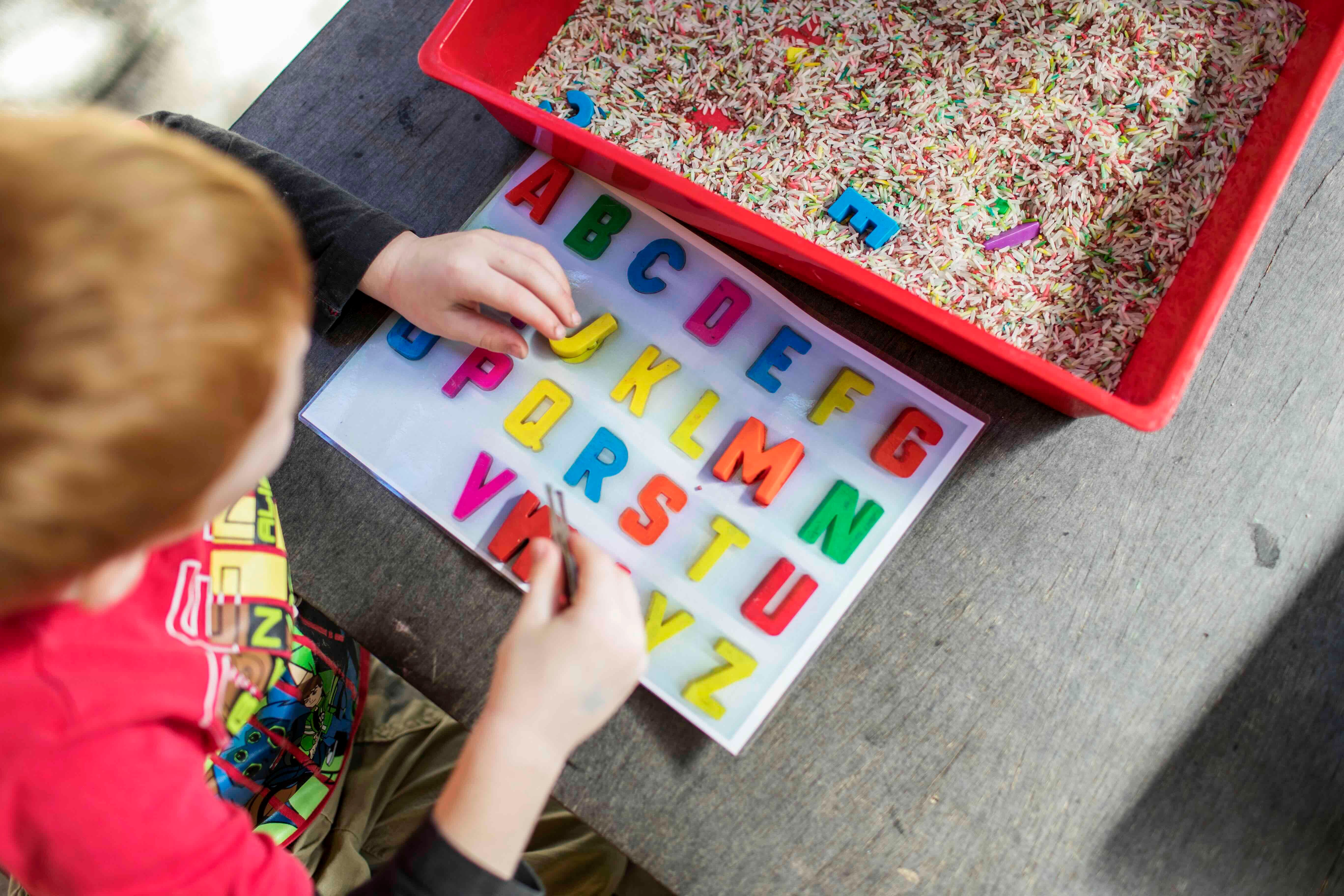 child playing with letters