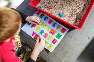 child playing with letters