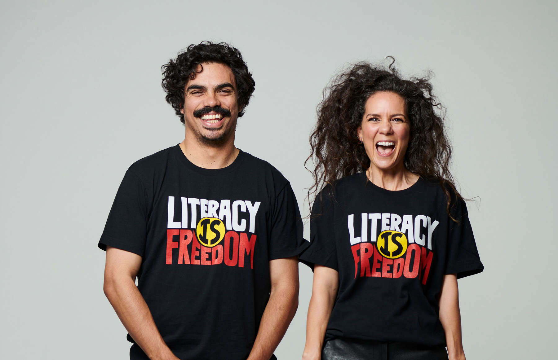 Two of ALNF ambassadors smiling wearing "Literacy is Freedom" t shirts 